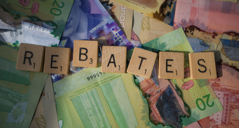 Picture of Canadian money with scrabble tiles saying "rebates" to depict story on Canada homeowner rebates.